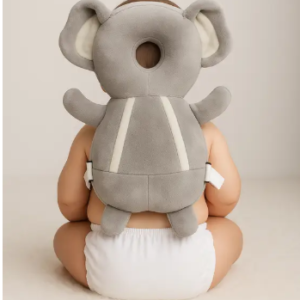 Baby wearing Pink Uv elephant head protector while crawling on floor