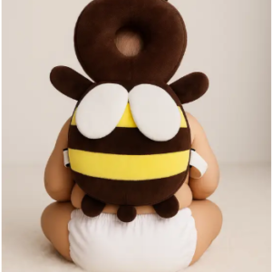 aby wearing Pink Uv bee head protector cushion while sitting indoor